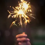 person holding lighted sparkler